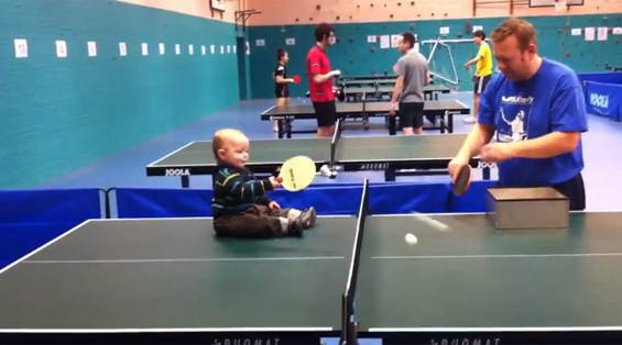 Бебе од една година игра пинг-понг