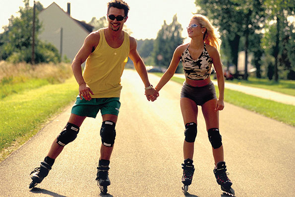 Paar mit Inline-Skatern auf Strasse