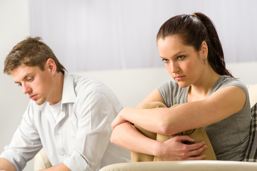Unhappy couple sitting silently after argument