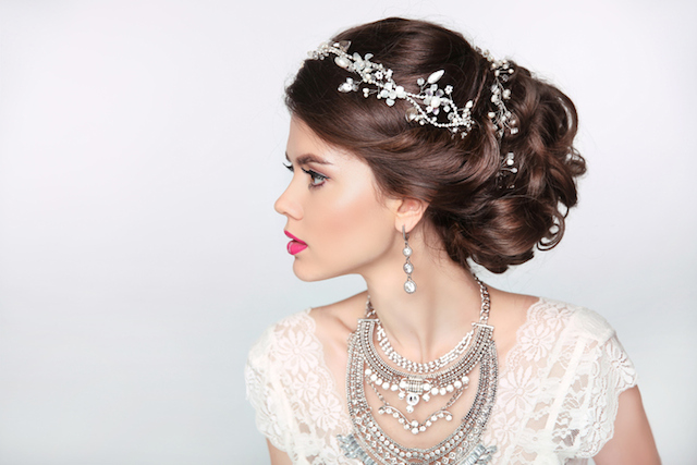 Beautiful elegant girl model with jewelry, makeup and retro hair