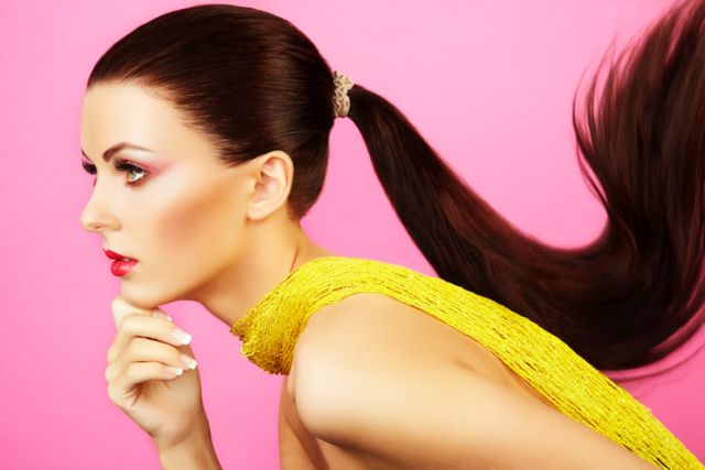 Fashion photo of  beautiful woman with  ponytail. Beauty woman on pink background