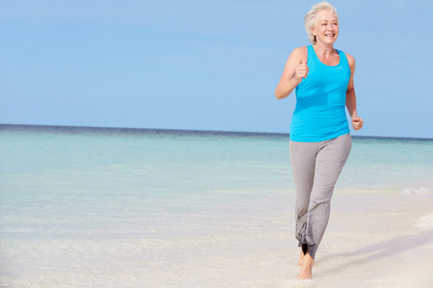Senior Woman Running On Beautiful Beach