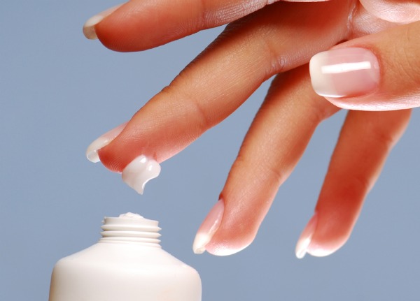 Moisturizer on the end of woman finger.