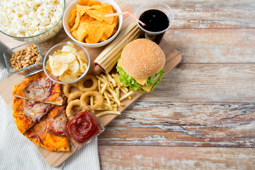 close up of fast food snacks and drink on table